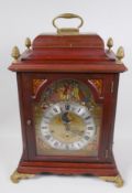 A Dutch walnut cased bracket clock with chiming movement and moon phase, the dial embossed and
