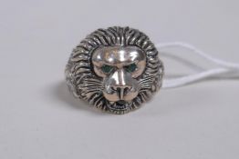 A 925 silver lion's mask ring with emerald set eyes, size N/O