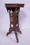 An antique Moorish lamp table with Islamic calligraphy and carved decoration, inlaid with mother