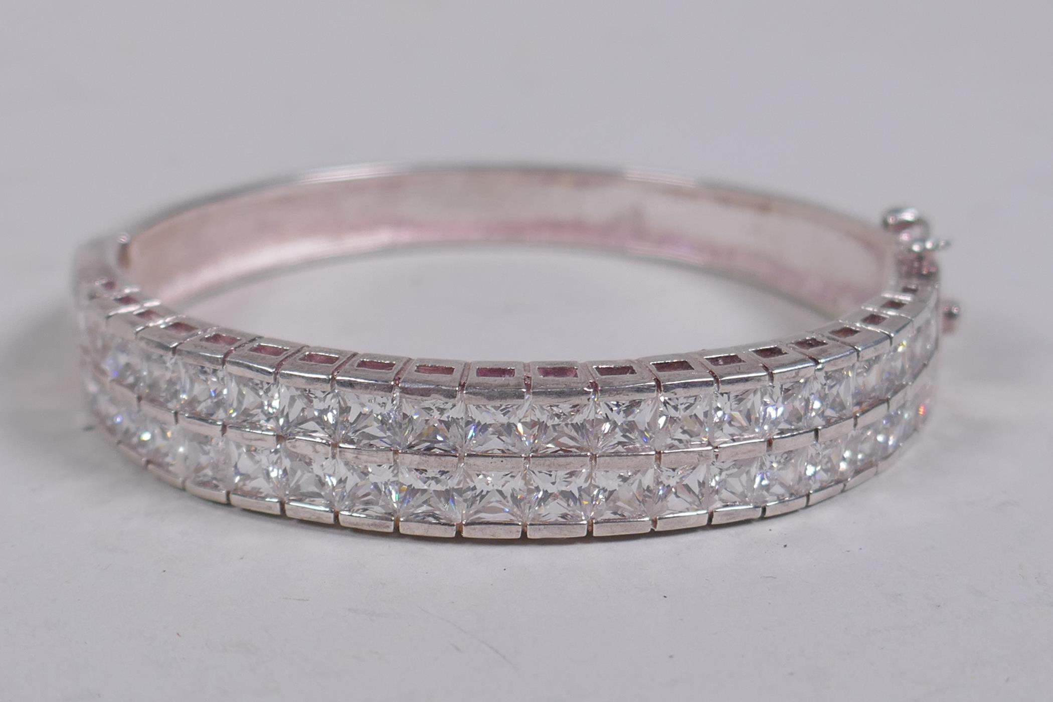 A silver and cubic zirconia set bangle, 6.5cm diameter