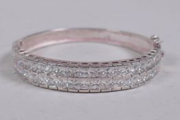 A silver and cubic zirconia set bangle, 6.5cm diameter