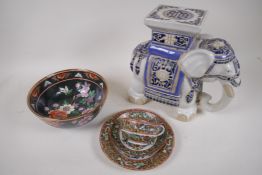 A Chinese porcelain bowl with brightly painted embossed flowers on a black ground, six character