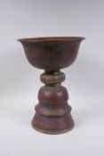 A Tibetan copper and brass butter lamp, 33cm high