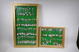 A quantity of collector's tea spoons, mostly topographical interest, framed, largest 38 x 66cm