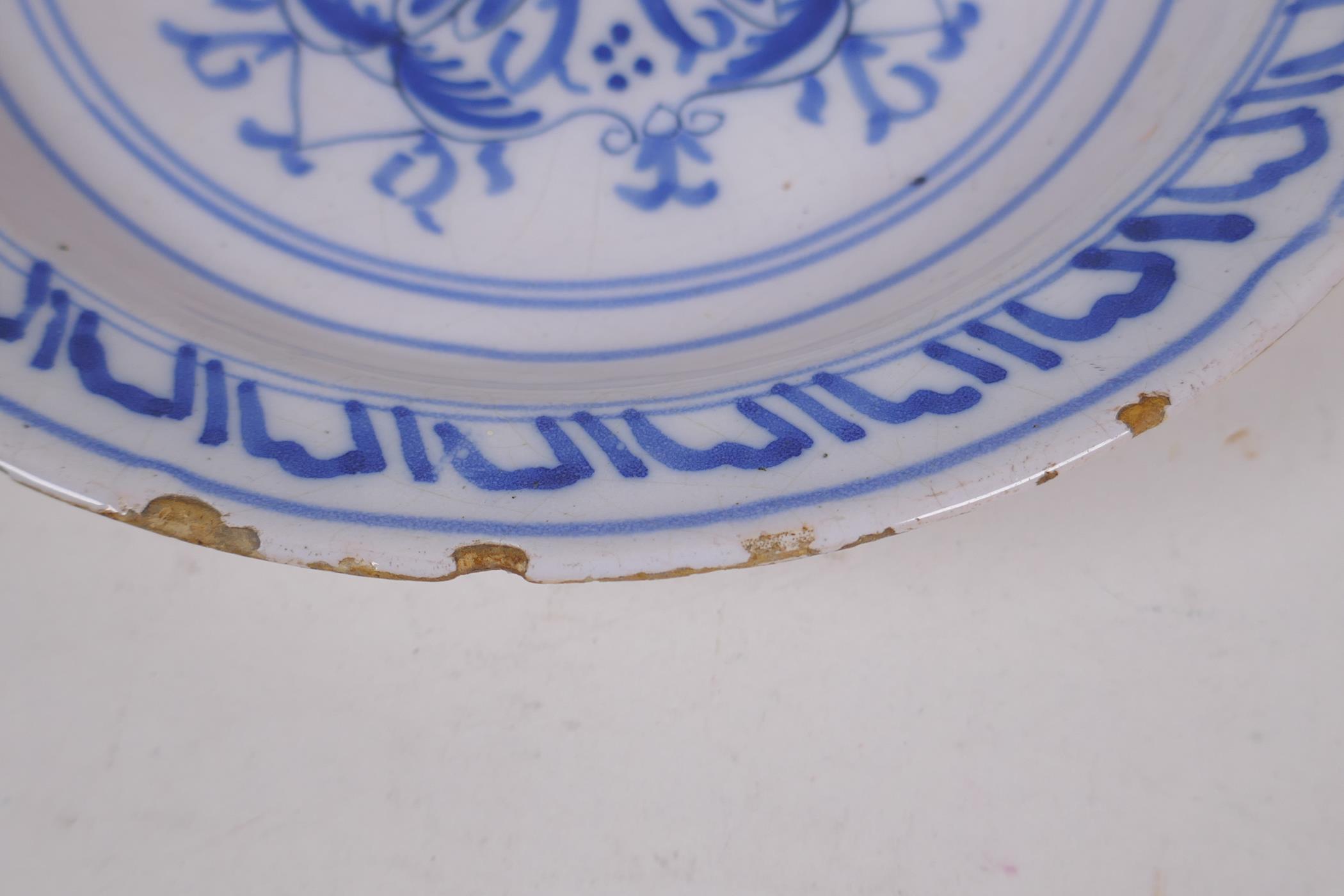 A late C18th/early C19th Delft tin glazed blue and white pottery bowl painted with flowers, 22cm - Image 2 of 4