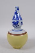 A Chinese blue and white porcelain double gourd vase with a yellow glazed lower section, 21cm high