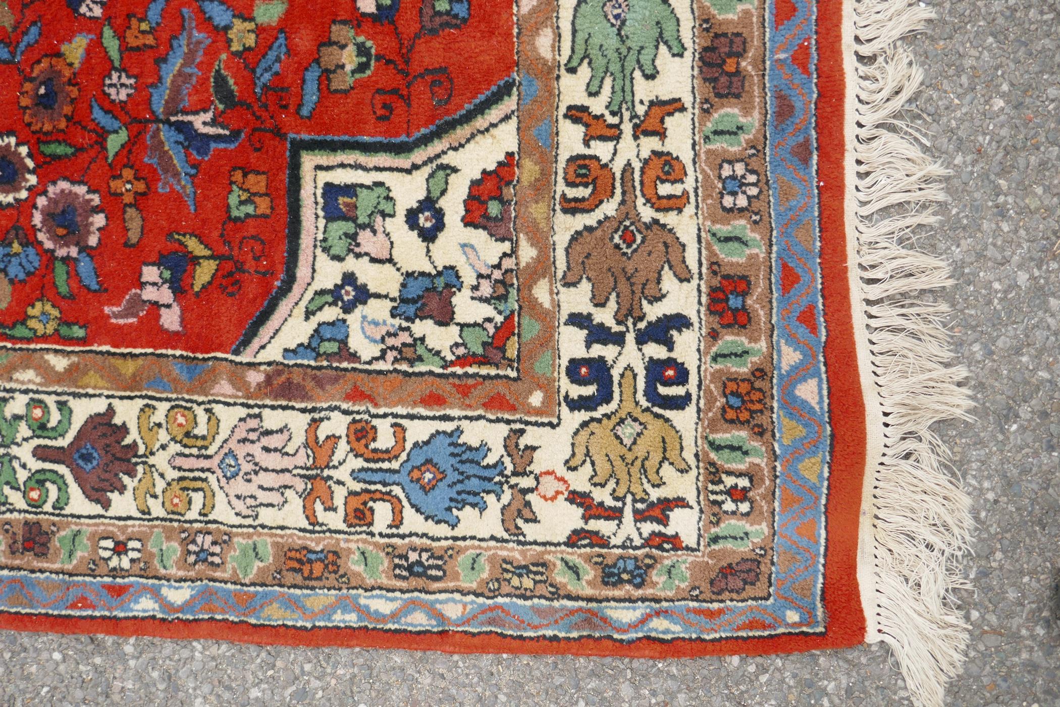 An eastern red ground hand woven wool carpet decorated with a multicolour flower and bird design, - Image 4 of 5