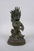 A Sino Tibetan bronze figure of a wrathful deity seated on a pig, 22cm high