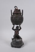 A Japanese bronze censer and cover held aloft by an oni, 30cm high