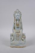 A Chinese celadon glazed porcelain figure of Quan Yin, 24cm high