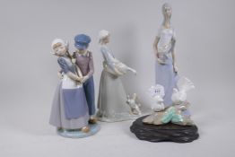 A Lladro figure group, a Nao figure and two Spanish porcelain figures, largest 34cm high