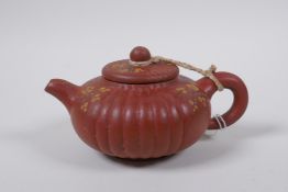 A Chinese YiXing teapot with enamelled prunus decoration, impressed mark to base, 11cm diameter