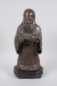 A Chinese filled bronze of Shao Lao, on a hardwood stand, 34cm high