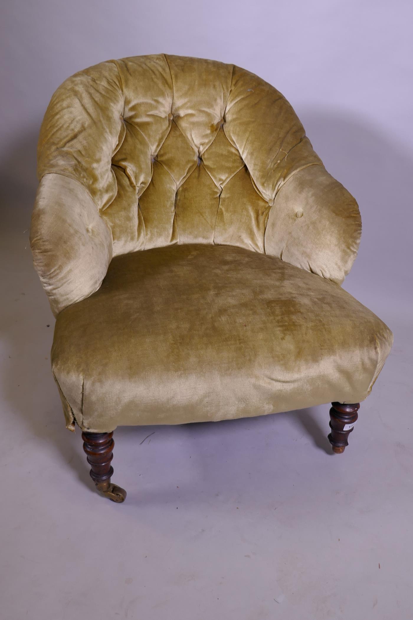A Victorian button back tub armchair, raised on turned supports with brass castors - Image 2 of 2