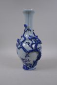 A Chinese blue and white porcelain vase with applied raised peach tree decoration, Qianlong seal