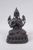 A Tibetan bronze figure of Buddha in traditional pandita hat, 24cm high