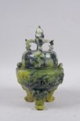 A Chinese mottled green soapstone censer and cover on tripod supports, with carved phoenix