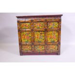 An oriental painted hardwood side cabinet with an imitation bamboo frame, 66 x 28cm, 60cm high