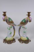 A pair of polychrome porcelain parrot candlesticks with bronze mounts, 41cm high