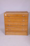 A mid century teak chest of four long drawers, 77cm s 41cm, 74cm high