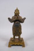 A Chinese filled bronze of a warrior, seal mark to the reverse, 22cm high