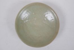 A Chinese Sung style celadon glazed dish with underglaze floral decoration, 16cm diameter