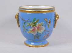 A blue glaze planter with hand painted floral design and gilt highlights with ring handles,