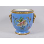 A blue glaze planter with hand painted floral design and gilt highlights with ring handles,