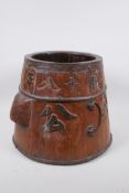 An antique Chinese metal bound elm conical barrel child minder, with carved character inscription,