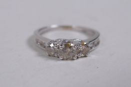 A 10ct white gold diamond ring, with three central stones and stone set shoulders, size N