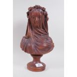 A glazed terracotta bust of a woman in a veil, 35cm high