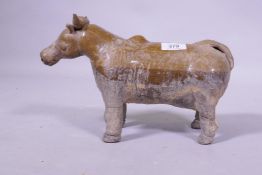 An antique Eastern glazed terracotta figure of a cow, probably North Indian, 30cm long x 20cm