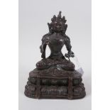 A Sino Tibetan bronze of Buddha seated on a lotus throne, 19cm high