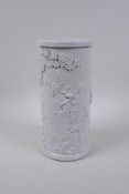A Chinese blanc de chine porcelain brushpot decorated with figures in a landscape, impressed seal