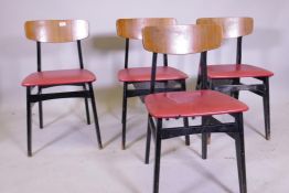 Four mid century dining chairs with teak veneered back rests and ebonised bases