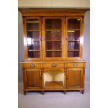 A C19th oak dresser, the upper section with three glazed doors, the base with three drawers over two