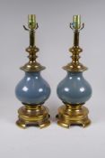 A pair of French gilt and painted metal lamps, 50cm high