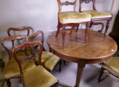 A mahogany wind out dining table, raised on turned supports with pad feet and a harlequin set of