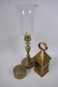 An engraved brass candlestick with glass storm shade, 43cm, a brass lantern and an engraved and
