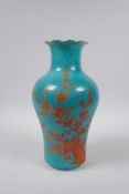 A Chinese turquoise ground porcelain vase with frilled rim and iron red bird and blossom decoration,