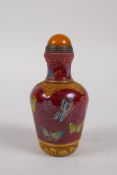 A Chinese moulded glass snuff bottle with enamelled butterfly decoration, 4 character mark to