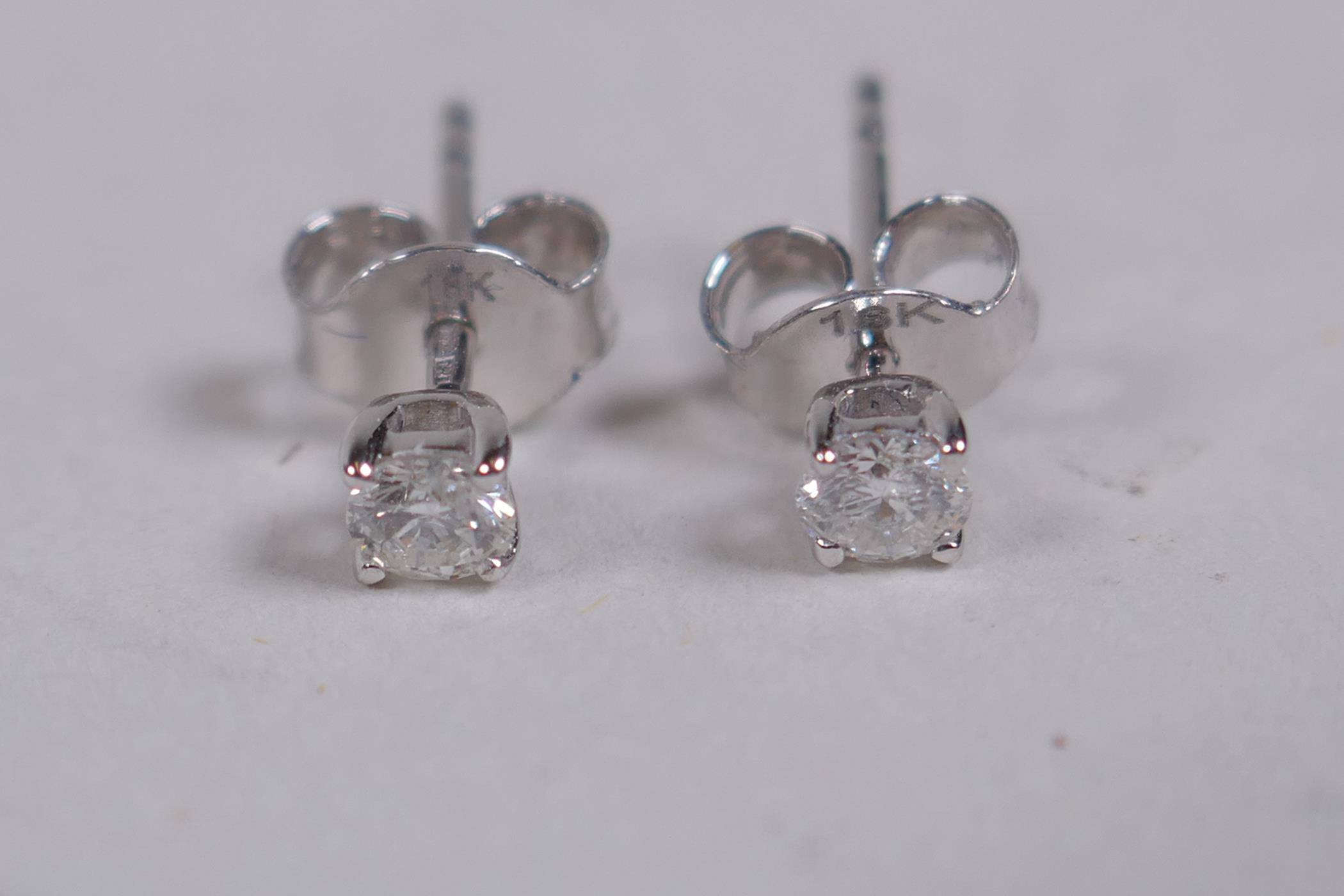 A pair of 18ct white gold stud earrings, approx 30 points