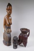 An African carved wood figure, and two others, 65cm high