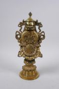A Sino Tibetan bronze ornament depicting the Buddhist treasures, impressed double vajra mark to