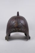 An antique Chinese warring states style bronze helmet, 29cm high