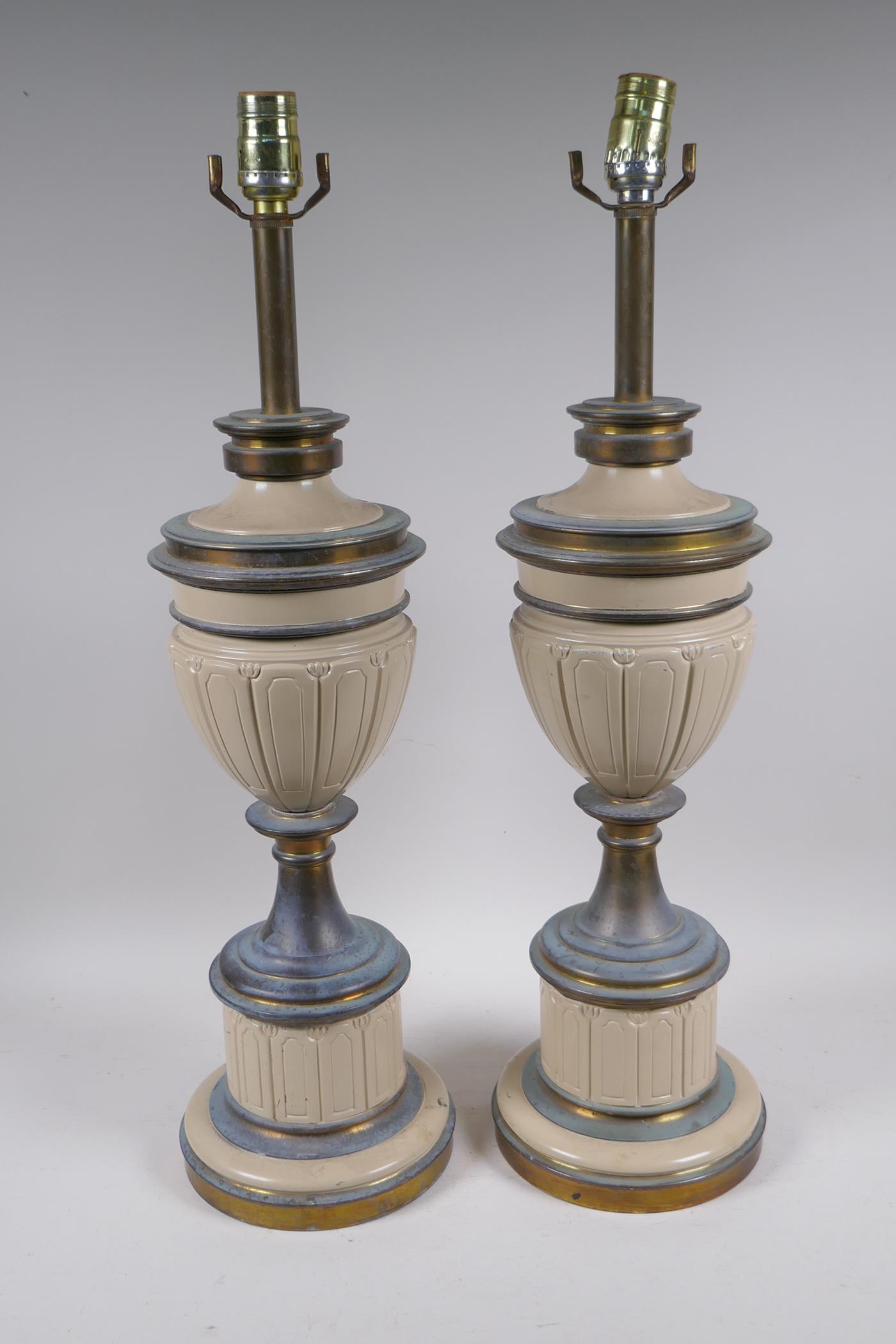 A pair of French painted and brassed metal lamps, in the form of urns, 65cm high