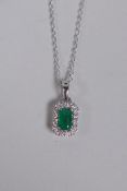 An 18ct white gold, emerald and diamond set pendant necklace, approx 40 points