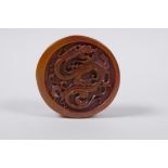 A Chinese amber soapstone cylinder seal, with dragon decoration to the top, 6cm diameter