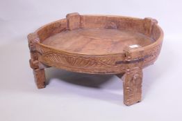 A South East Asian carved fruitwood low trough table, with metal straps, 80cm diameter x 29cm high