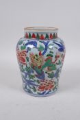 A Chinese wucai porcelain jar with kylin and floral decoration, 17cm high